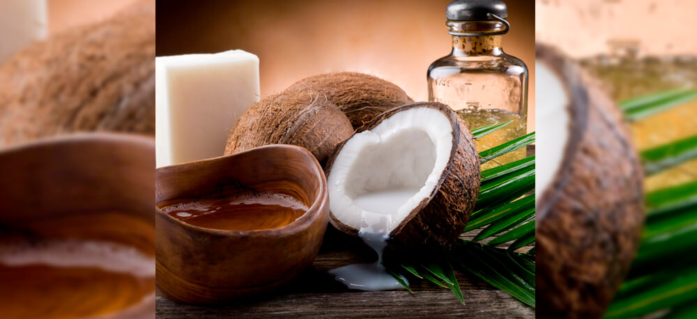 Кокосова олія, поряд кокос, з якого виливається кокосове молоко